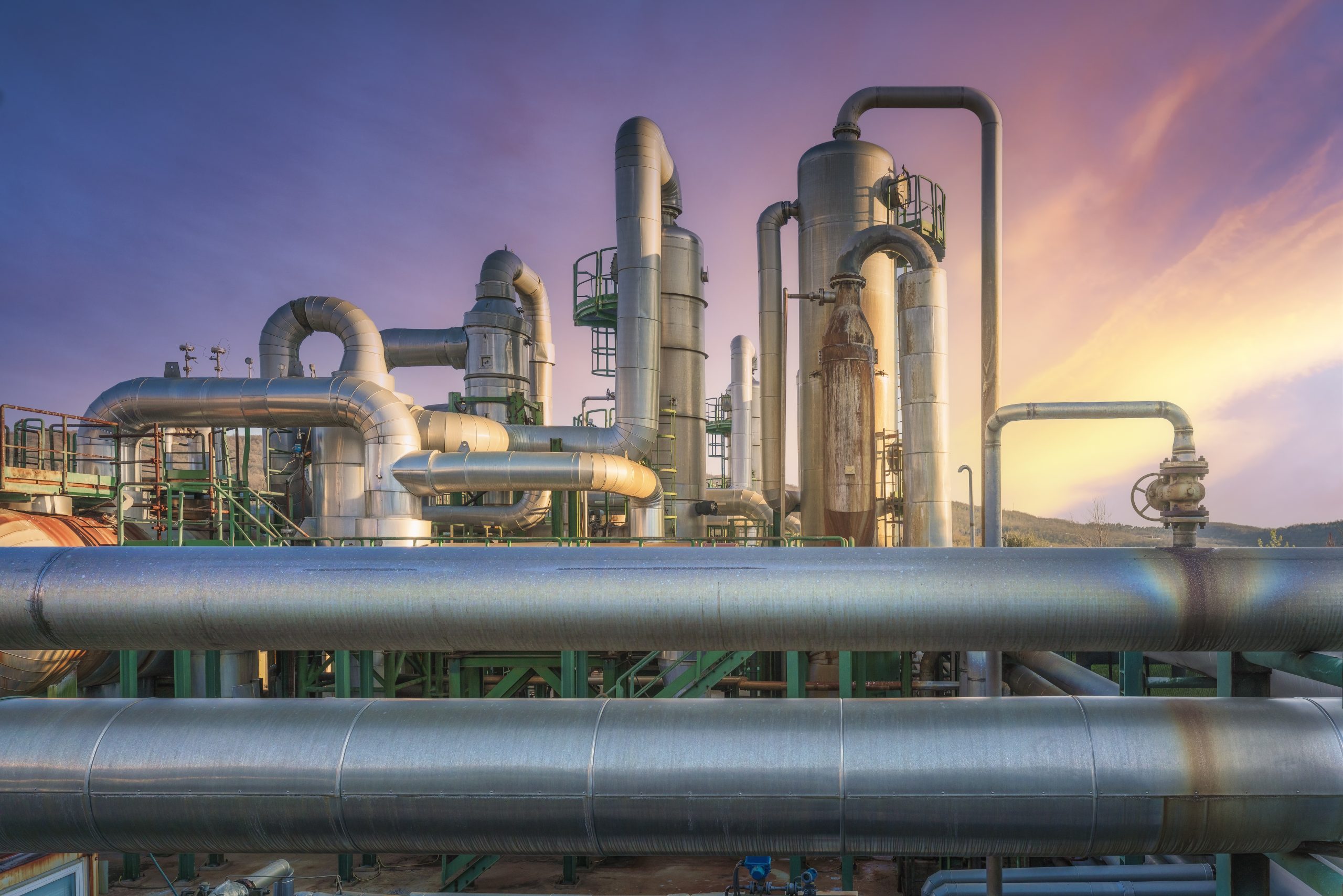 Pipeline of a geothermal power plant at sunset in Larderello, Tuscany region, Italy. Geothermal power is a form of alternative and sustainable energy production.