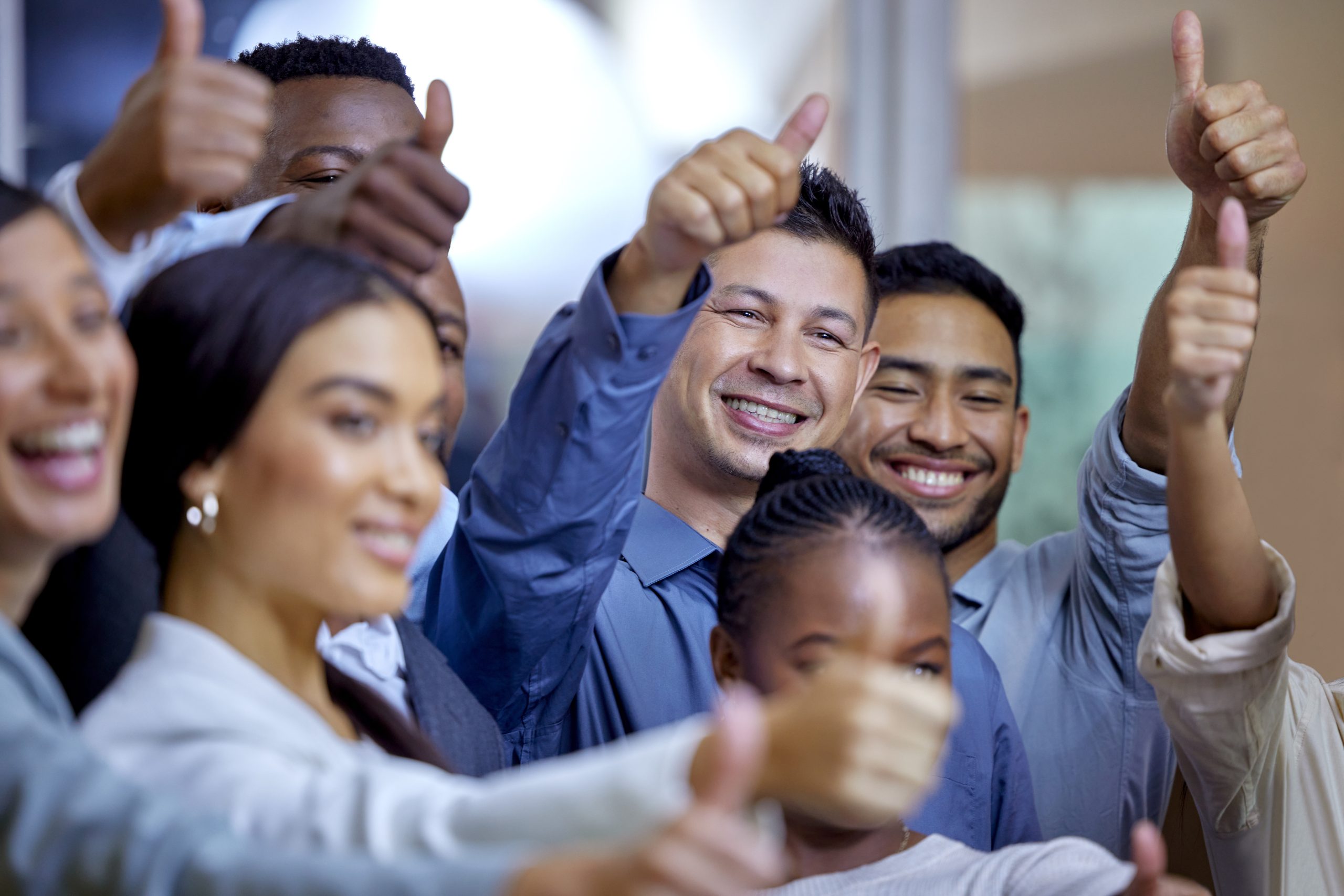 Make it our problem. Shot of a group of businesspeople showing the thumbs up in a modern office