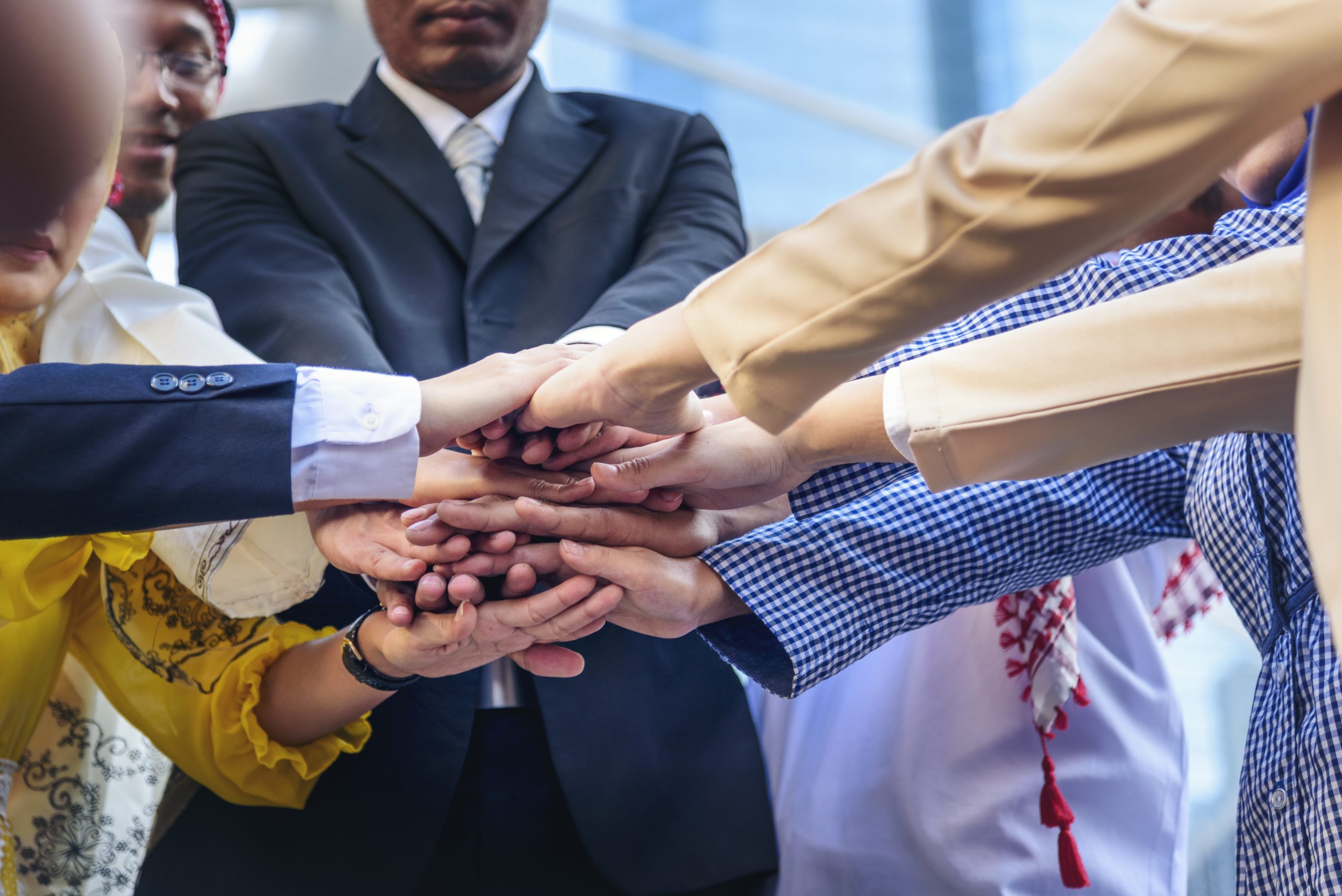 Diverse multiethnic Partners hands together teamwork group of multi racial people meeting join hands togetherness. Diversity people hands join empower partnership teams connection volunteer community